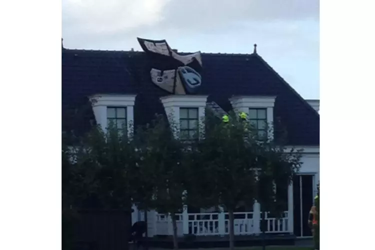 Kitesurfer gewond bij crash in Andijk: vlieger door brandweer van dak gehaald